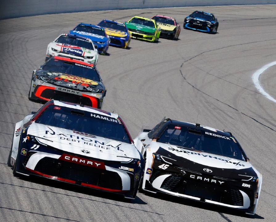 Denny Hamlin (11) and Tyler Reddick (45) race side-by-side through